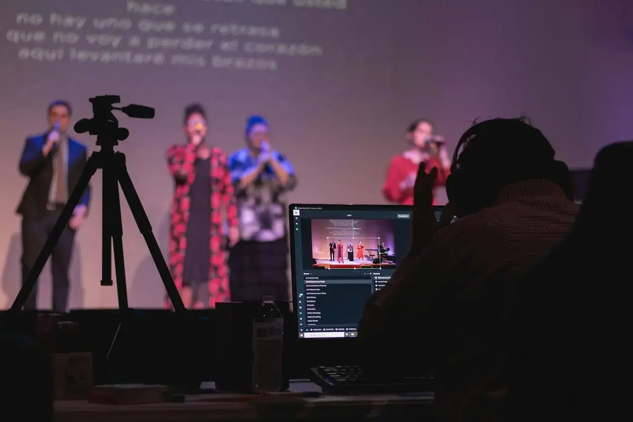 people on stage using audio equipment
