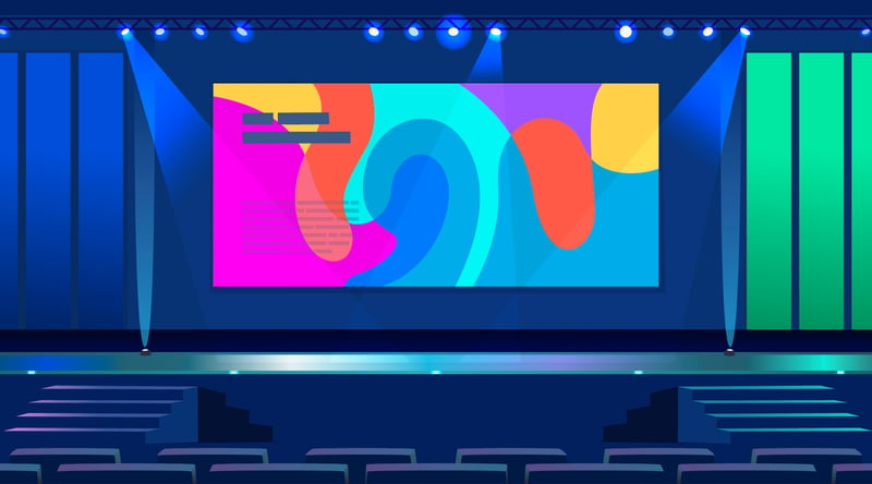 a lit up stage with a projection of some type of content. Live events need the environment to be set up in a way that keeps the audience in mind.