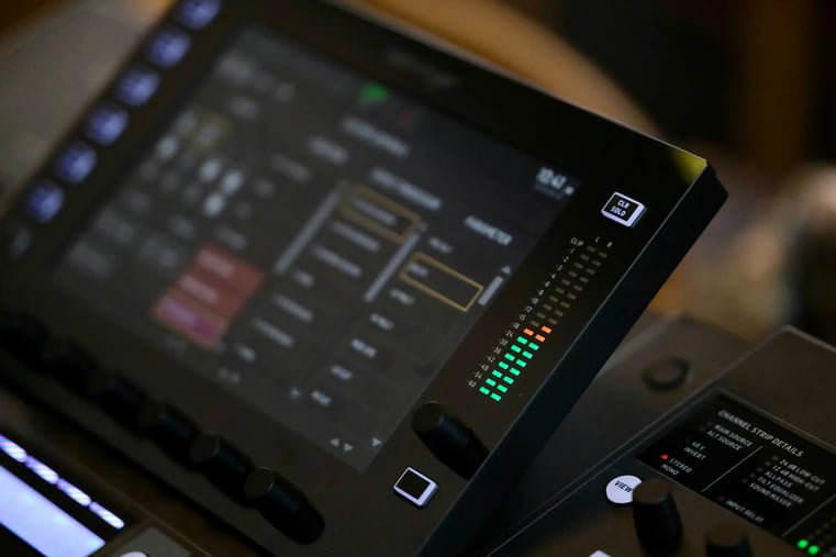 Close-up of an audio mixer's EQ knobs and input jacks