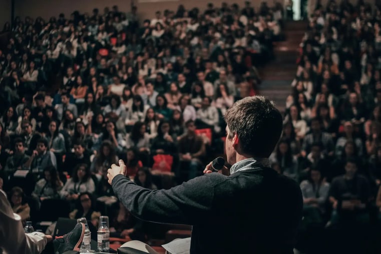 Speaker addressing employees at a corporate conference