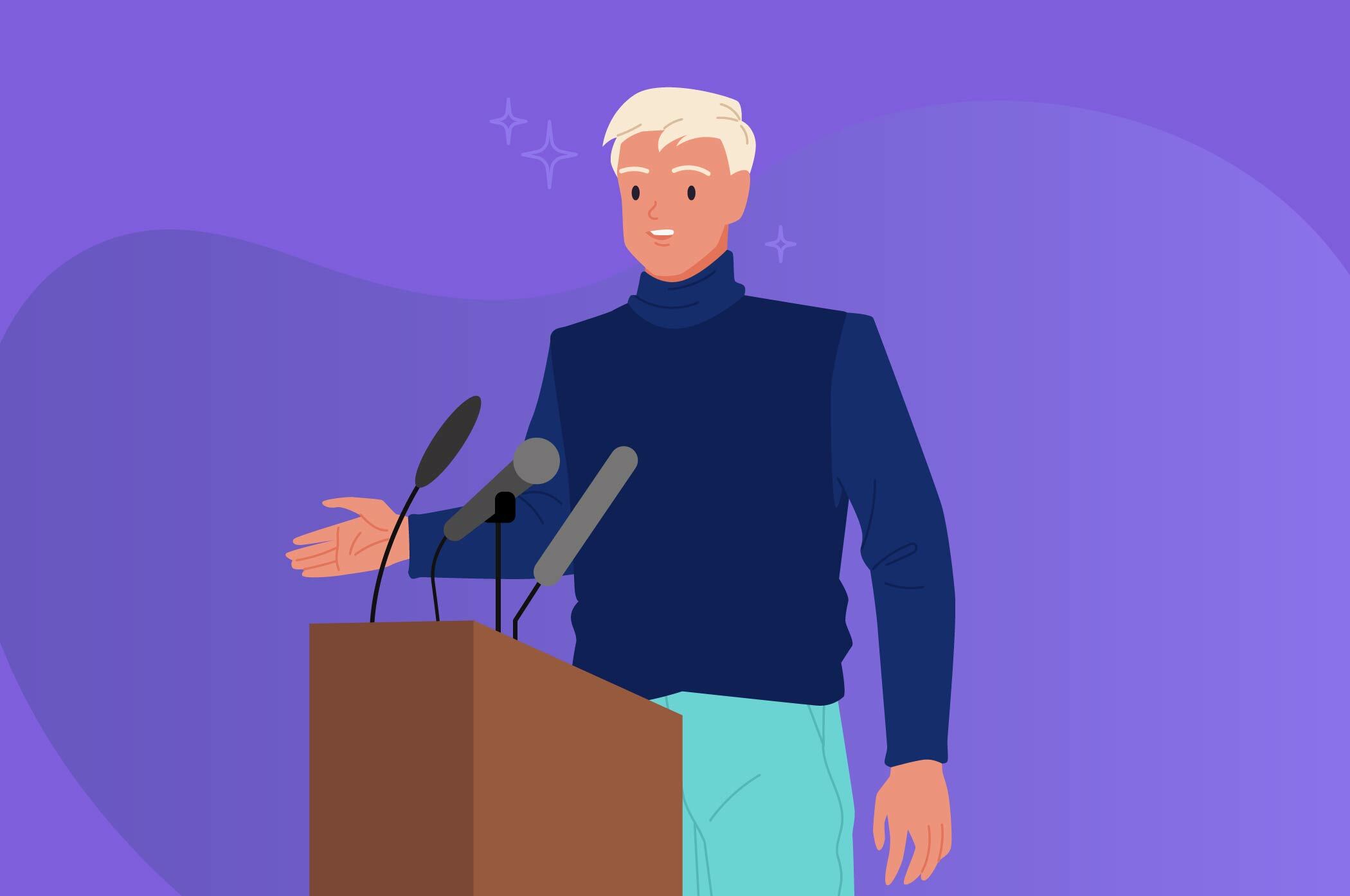 blonde haired man standing on stage behind a podium